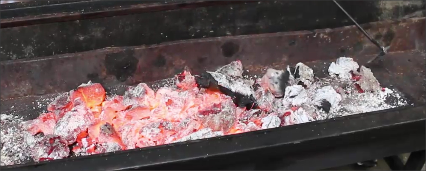 This image shows hot charcoal in a spit roaster